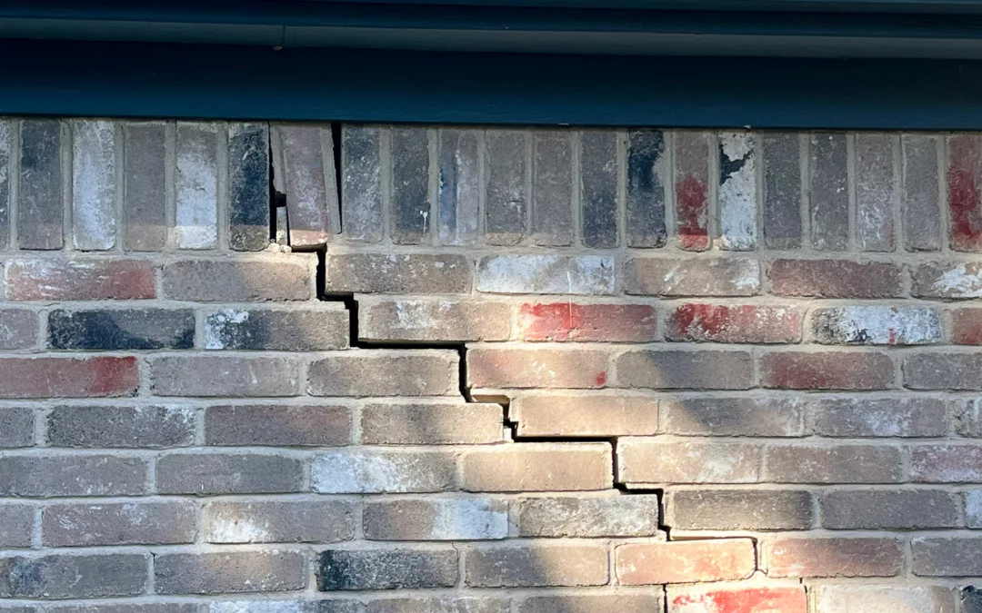 The most common visual sign that your home foundation has issues, cracks on a brick wall.